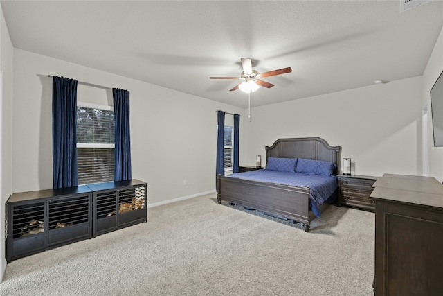 bedroom with ceiling fan and light carpet