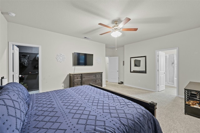 carpeted bedroom with ceiling fan and ensuite bathroom