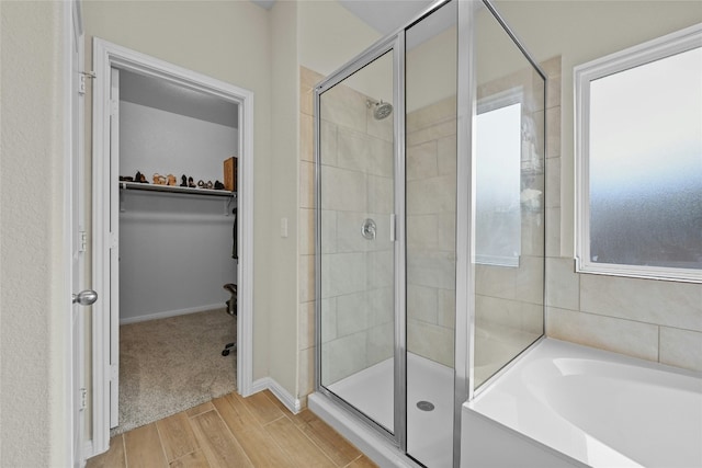 bathroom featuring hardwood / wood-style floors and independent shower and bath