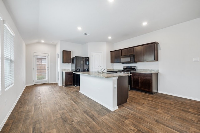 kitchen with black appliances, a center island with sink, dark brown cabinetry, and dark wood-type flooring