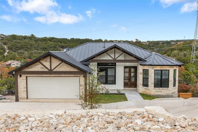 view of front of home with a garage and french doors