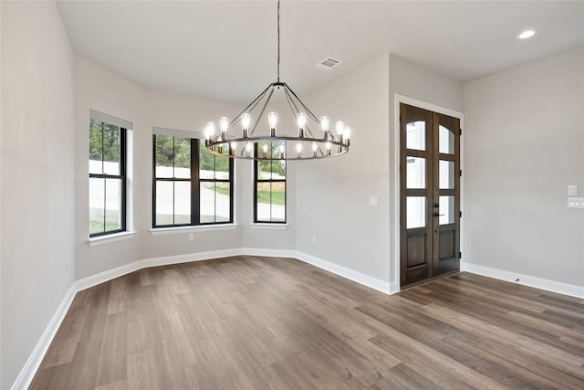 foyer featuring hardwood / wood-style floors and a notable chandelier