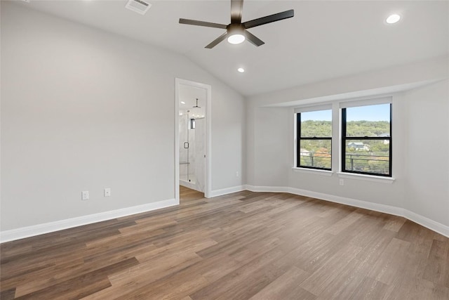 empty room with ceiling fan, lofted ceiling, and light hardwood / wood-style flooring