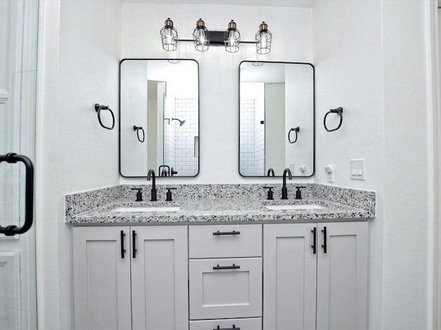 bathroom featuring a shower and vanity