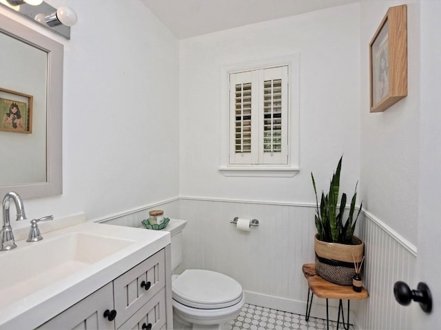 bathroom featuring vanity and toilet