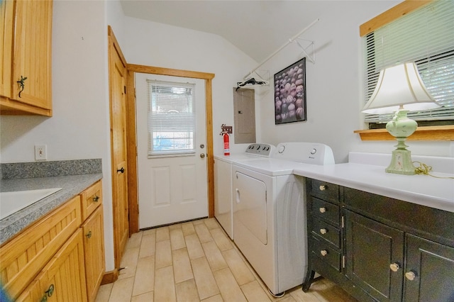 laundry room with washer and clothes dryer, cabinets, sink, and electric panel