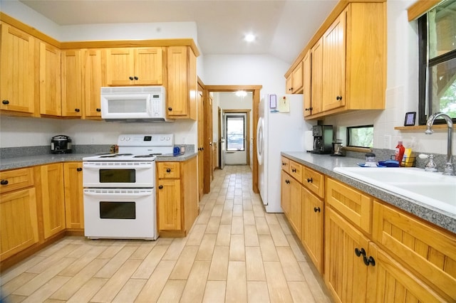 kitchen with white appliances, light hardwood / wood-style floors, lofted ceiling, and sink