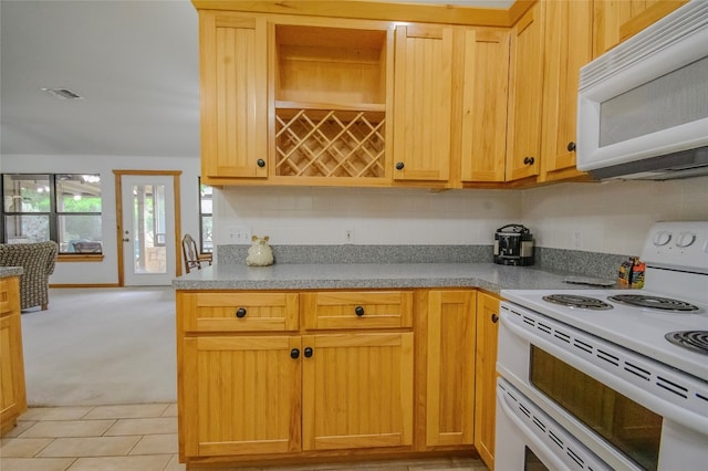 kitchen featuring decorative backsplash, light carpet, and white appliances