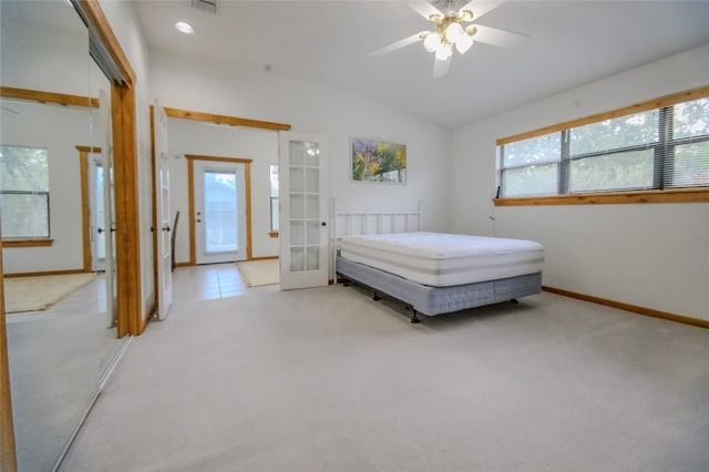 bedroom featuring french doors, light colored carpet, vaulted ceiling, and ceiling fan