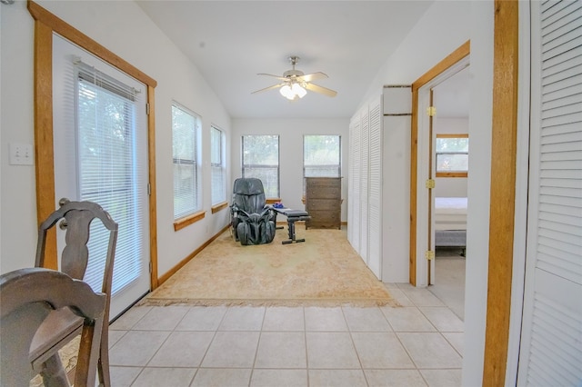 sunroom / solarium with plenty of natural light, lofted ceiling, and ceiling fan