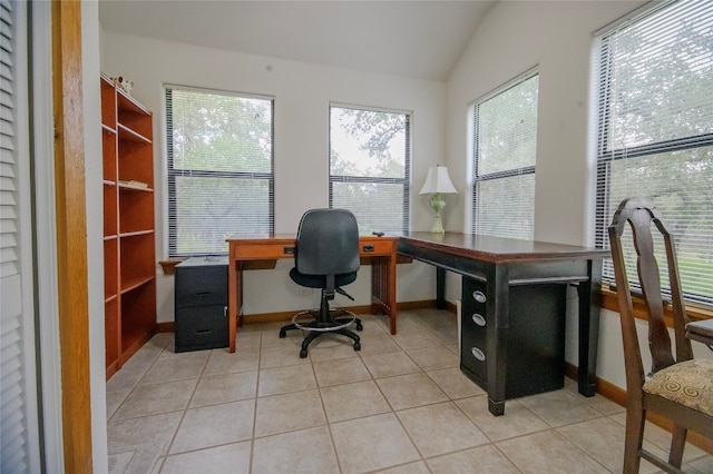 office with light tile patterned floors and lofted ceiling