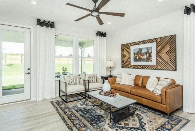 living room featuring hardwood / wood-style floors and ceiling fan