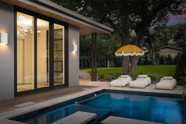 view of pool featuring a yard and a wooden deck