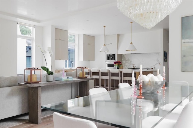 dining room featuring an inviting chandelier and light hardwood / wood-style flooring