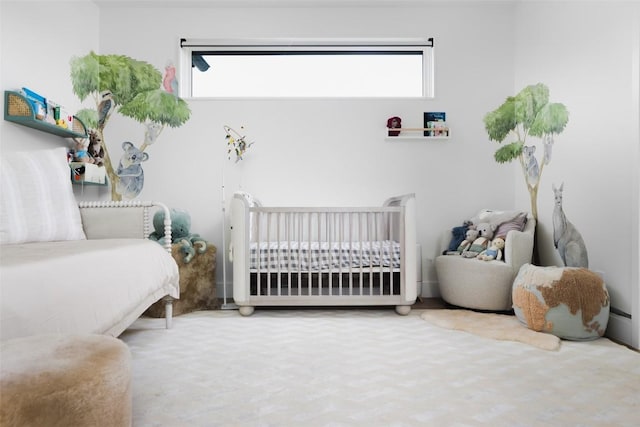 bedroom with a crib and carpet flooring