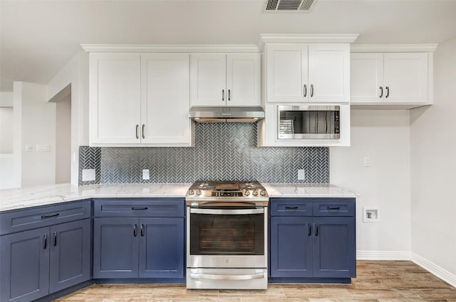 kitchen with blue cabinetry, stainless steel appliances, light stone counters, white cabinets, and light wood-type flooring