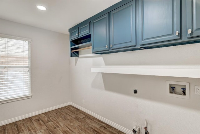 washroom featuring cabinets, hardwood / wood-style floors, electric dryer hookup, and washer hookup