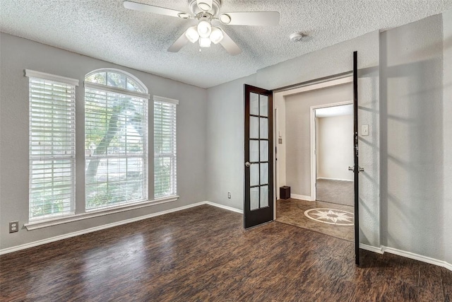 spare room with french doors, a textured ceiling, dark hardwood / wood-style floors, and ceiling fan