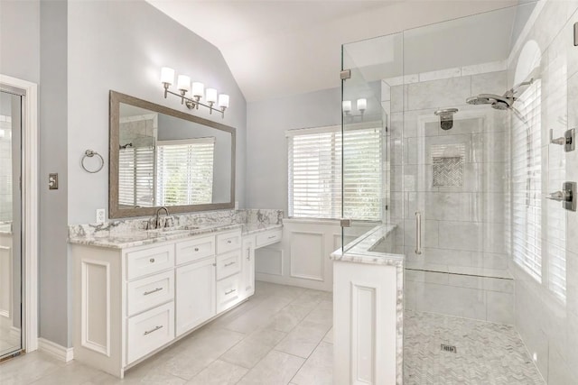 bathroom featuring vanity, tile patterned floors, a shower with shower door, and lofted ceiling