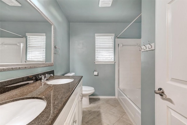 full bathroom with tile patterned flooring, vanity, toilet, and tiled shower / bath combo