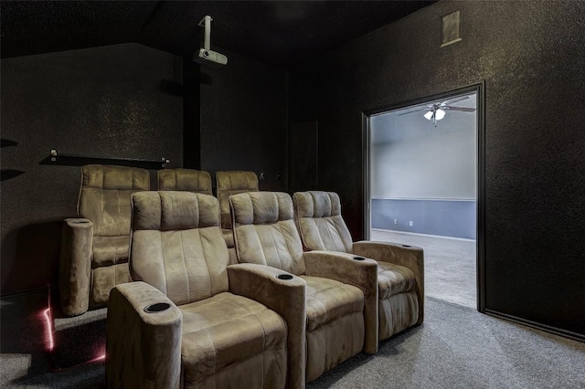 cinema with carpet flooring, vaulted ceiling, and ceiling fan