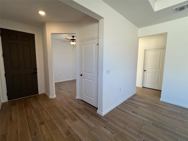 interior space featuring wood finished floors, visible vents, and baseboards