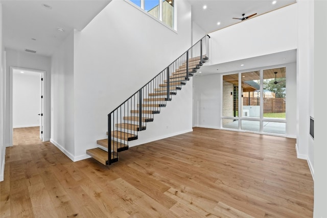 2206 Trail Of The Madrones, Austin, TX 78746 - stairs with hardwood / wood-style floors, a towering ceiling, and ceiling fan