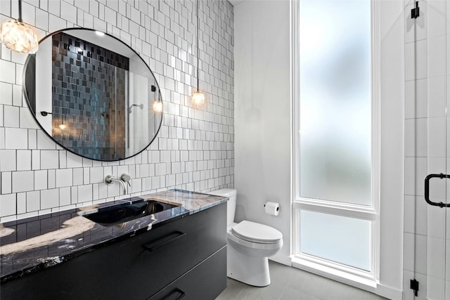 2206 Trail Of The Madrones, Austin, TX 78746 - bathroom featuring tasteful backsplash, tile patterned floors, toilet, a shower with door, and vanity