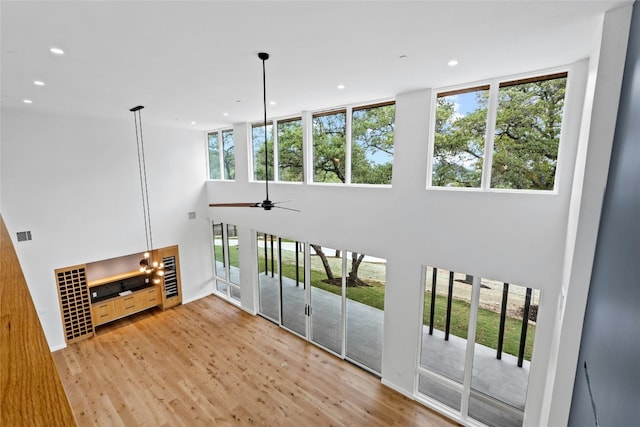 2206 Trail Of The Madrones, Austin, TX 78746 - living room featuring a wealth of natural light, ceiling fan, and light wood-type flooring