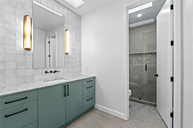 2206 Trail Of The Madrones, Austin, TX 78746 - bathroom featuring vanity, tile patterned floors, a skylight, toilet, and a shower with shower door