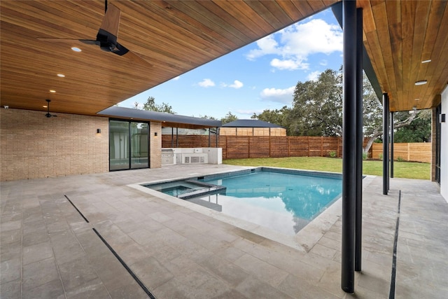 2206 Trail Of The Madrones, Austin, TX 78746 - view of swimming pool with ceiling fan, a yard, an in ground hot tub, a patio area, and exterior kitchen