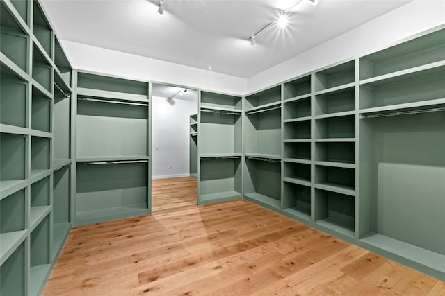 2206 Trail Of The Madrones, Austin, TX 78746 - spacious closet featuring hardwood / wood-style floors