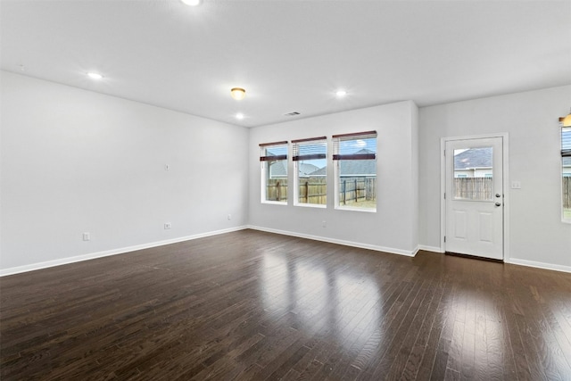 unfurnished living room featuring dark hardwood / wood-style flooring