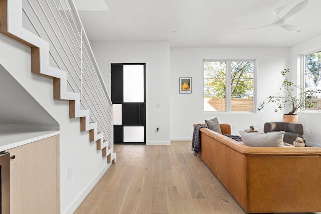 living room with ceiling fan and light wood-type flooring