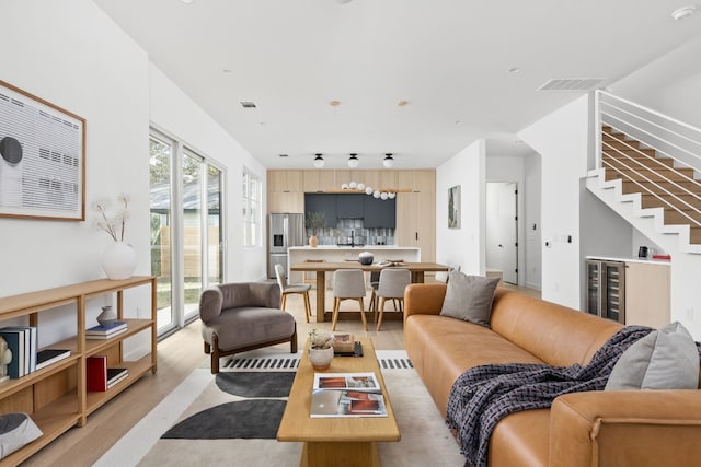 living room featuring light hardwood / wood-style floors and wine cooler