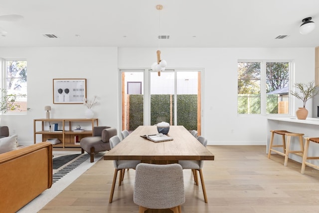 dining area featuring light wood-type flooring and a wealth of natural light