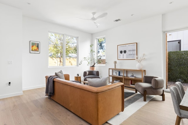 living room featuring ceiling fan and light wood-type flooring