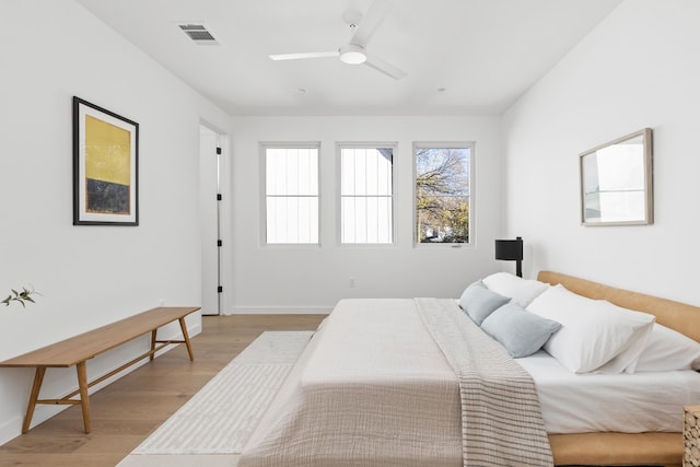 bedroom featuring light hardwood / wood-style floors and ceiling fan