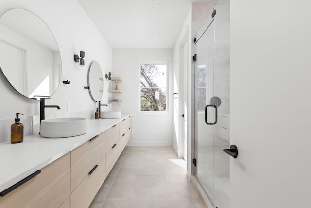 bathroom featuring vanity and an enclosed shower