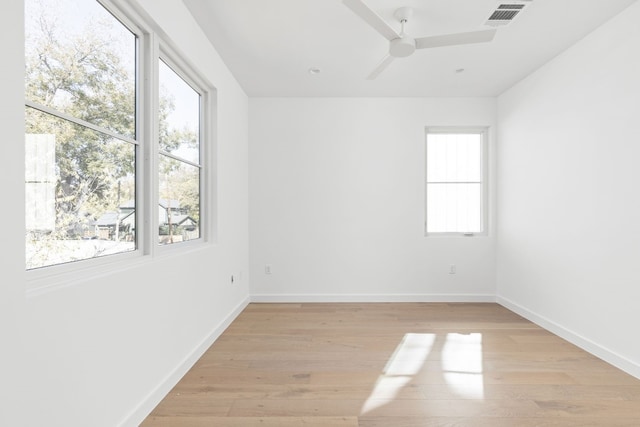 empty room featuring light hardwood / wood-style flooring, ceiling fan, and a healthy amount of sunlight