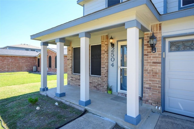 doorway to property with a lawn and a porch