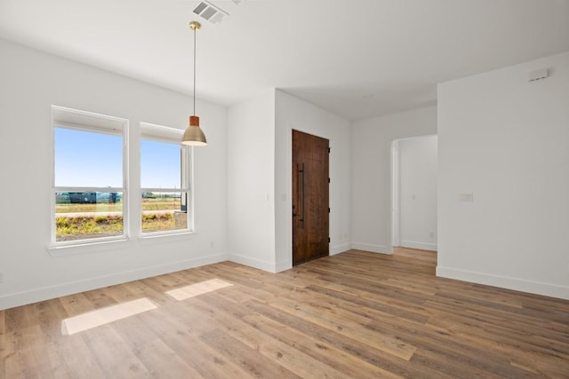 unfurnished room with wood-type flooring