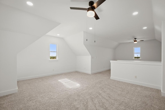 bonus room with plenty of natural light, lofted ceiling, and ceiling fan