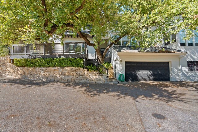 view of front of home with a garage and a wooden deck