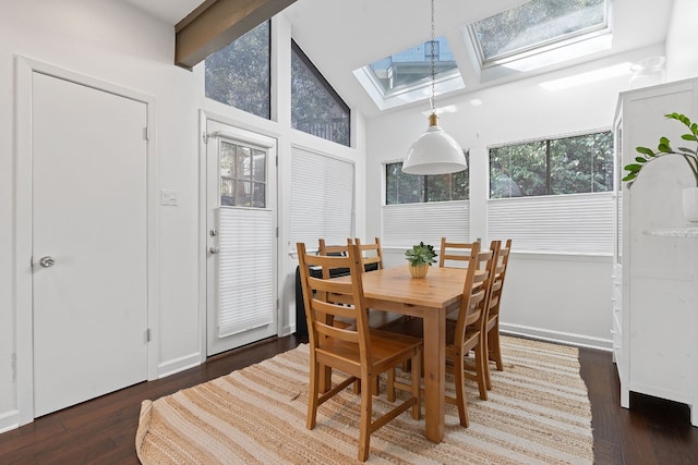 dining space with dark hardwood / wood-style flooring and lofted ceiling with skylight