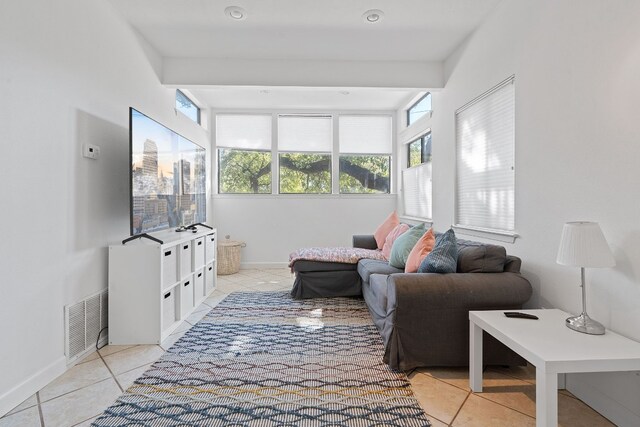 tiled living room with beamed ceiling