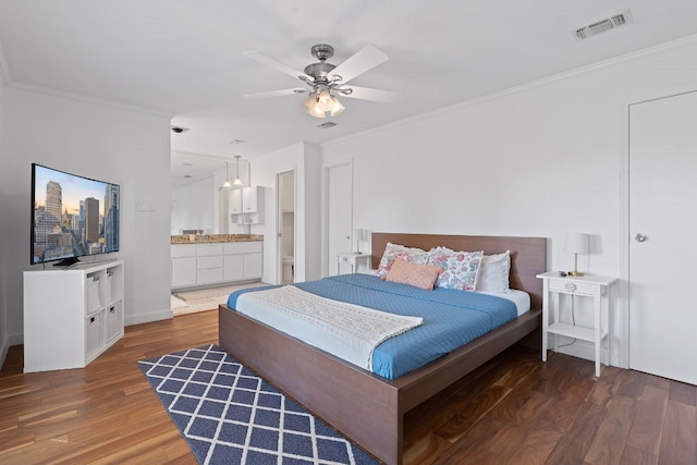 bedroom with connected bathroom, dark hardwood / wood-style floors, ceiling fan, and crown molding