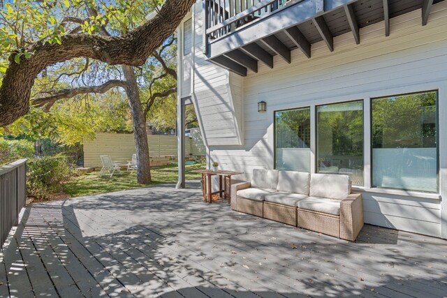 wooden terrace with an outdoor living space