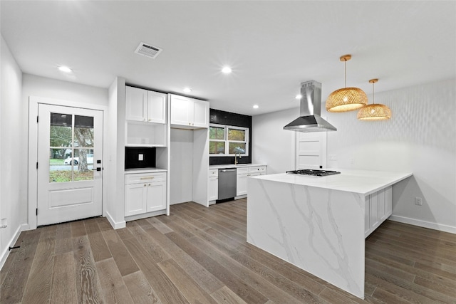 kitchen featuring white cabinets, hanging light fixtures, stainless steel dishwasher, a wealth of natural light, and island exhaust hood