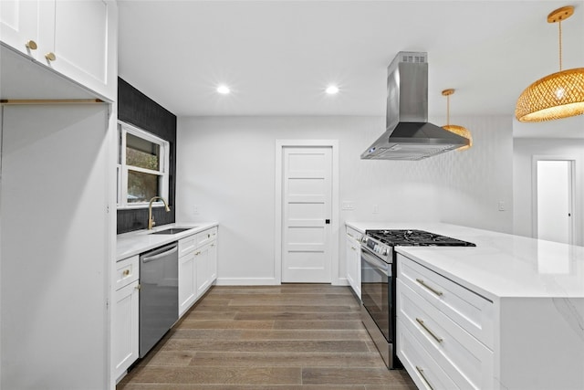 kitchen with ventilation hood, white cabinets, sink, hanging light fixtures, and appliances with stainless steel finishes